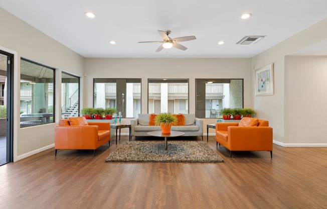 Living room with couches and a table at Verde Apartments in 85719