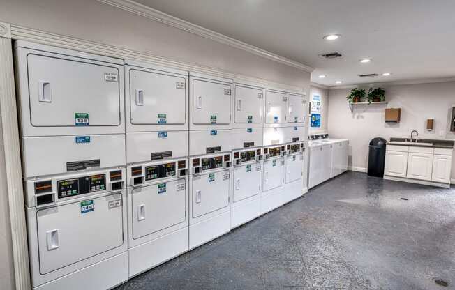 a utility room with many white utility machines in it