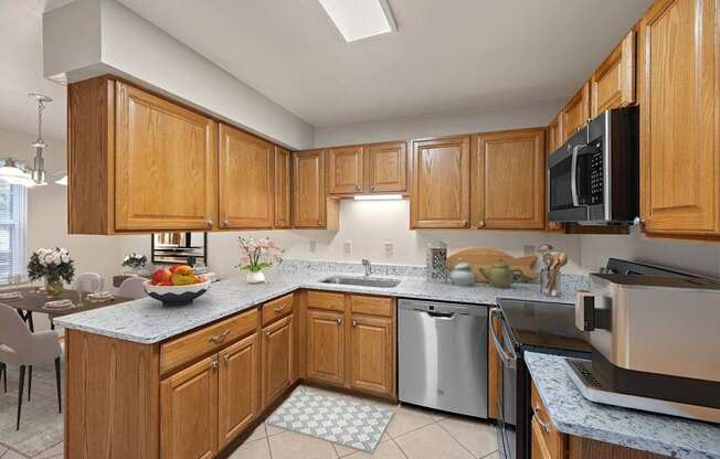 a large kitchen with wooden cabinets and stainless steel appliances