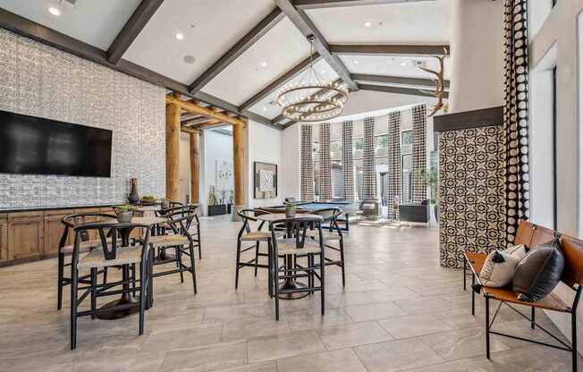 A modern dining room with a large table and chairs.