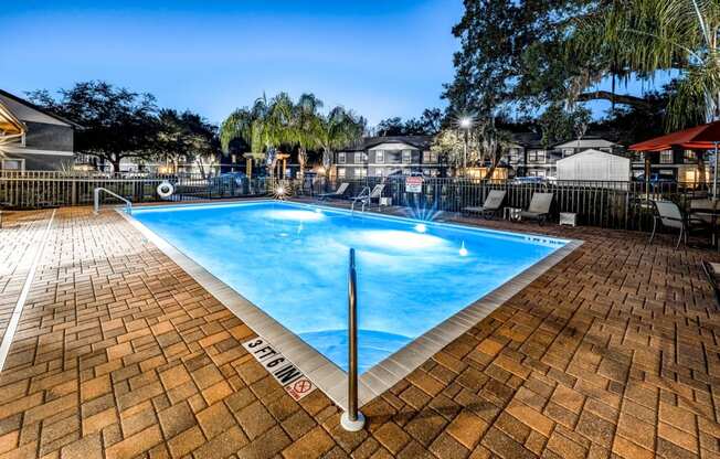 a swimming pool with blue water in a resort style pool