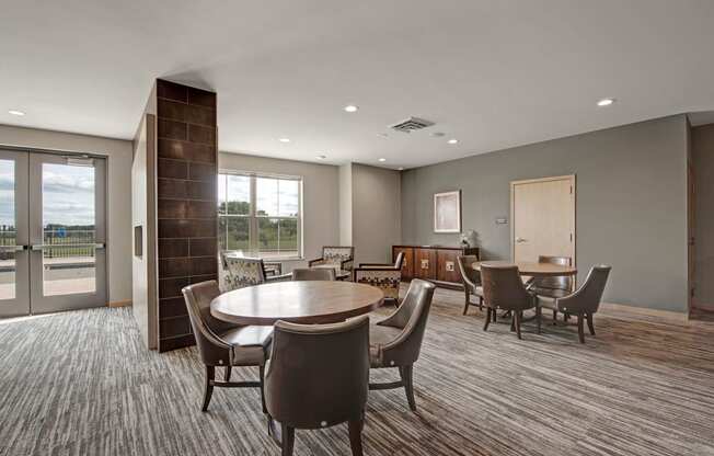 The Clubhouse at The Vue at Pinnacle Peak Apartment Homes Apartments in Fitchburg, WIed with furniture and a large window