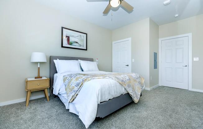 a bedroom with a bed and desk in a room