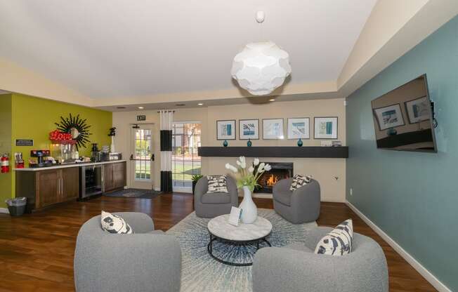 a living room with couches and chairs and a fireplace at Rocklin Manor  Apartments, California