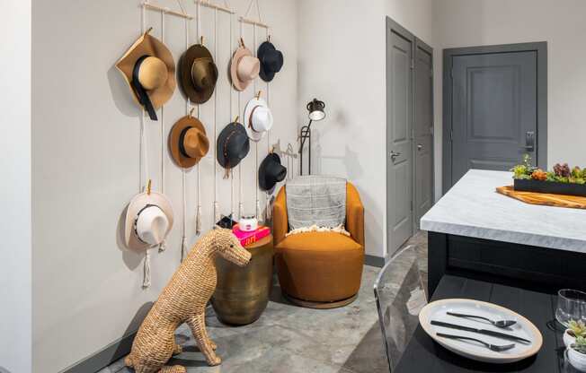 a selection of hats hangs from the wall in the entry of the apartment