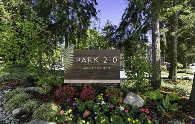 Park 201 Welcome Sign with Expertly Manicured Flowers and Trees at Park 210 Apartment Homes, Edmonds, Washington