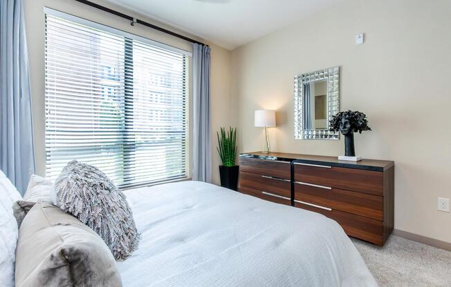 a bedroom with a large bed sitting next to a window