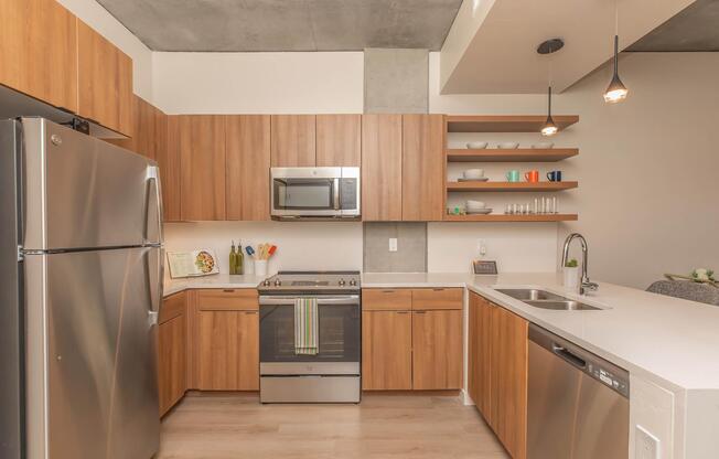 a kitchen with stainless steel appliances and wooden cabinets