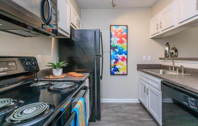 a stove top oven sitting inside of a kitchen