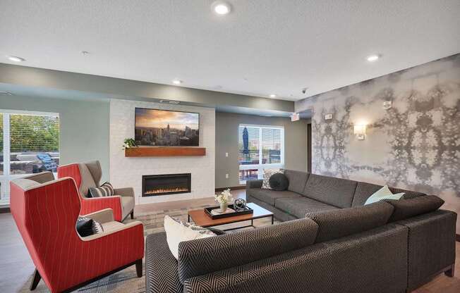 A living room with a fireplace and a painting on the wall.