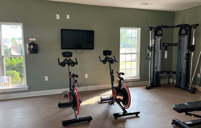 A home gym with exercise equipment and a television.