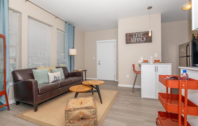 a living room filled with furniture and a large window