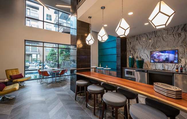 a restaurant with a long wooden counter and stools