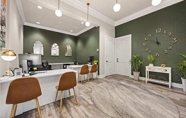 A room with a green wall and a white desk with chairs.