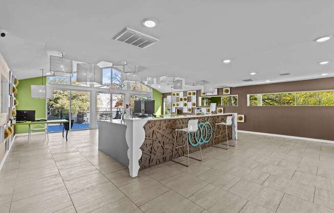 a lobby with a reception desk and a glass door