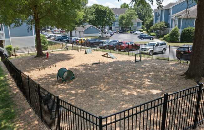 a playground in a fenced in area in a residential neighborhood