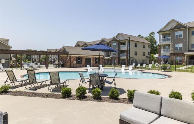 our apartments offer a swimming pool with chairs and umbrellas at The Maddox Apartments, Centerton, AR, 72719