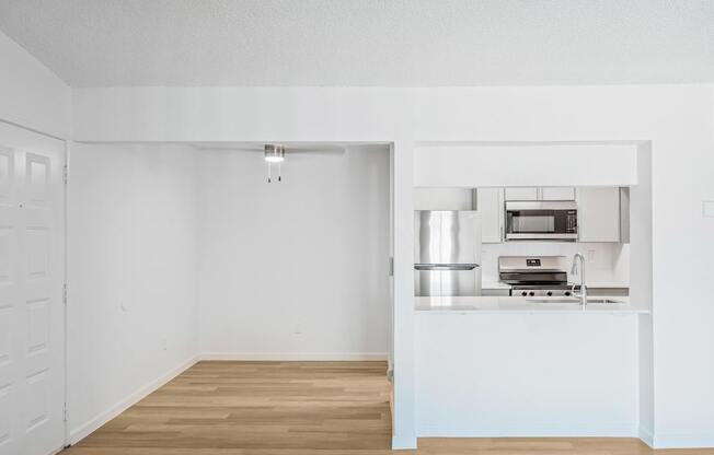 A kitchen with a stove top oven and a sink.