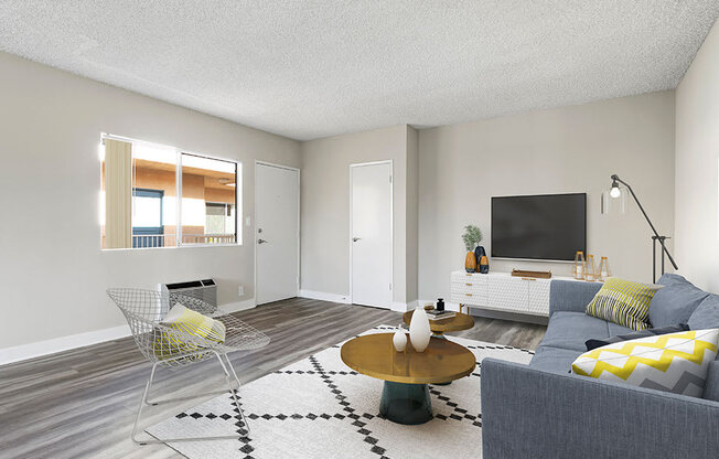 Spacious hardwood floor living room with view of courtyard.