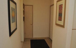 a hallway with a black rug and a door