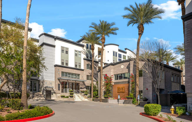 a view of the exterior of a building with palm trees