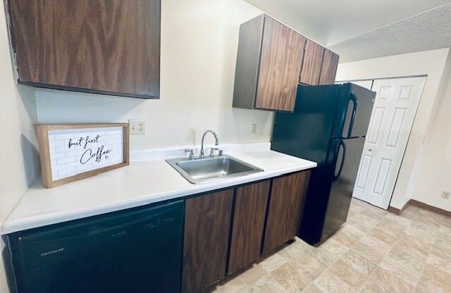 a kitchen with a sink and a refrigerator