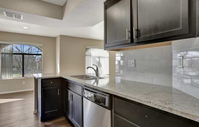 the renovated kitchen has granite counter tops and stainless steel appliances