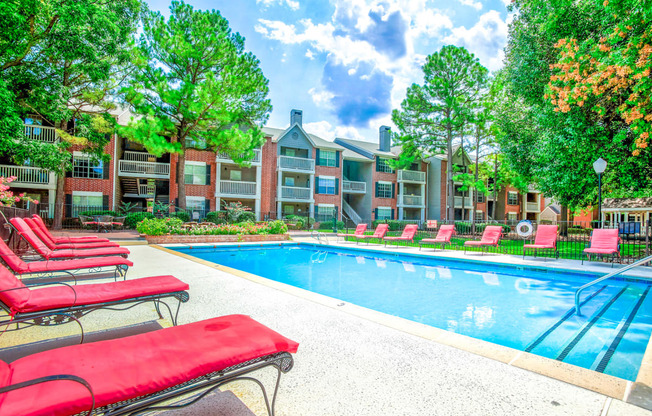 Sparkling pool with lounge chairs at Greenbriar Apartments in Tulsa, OK!