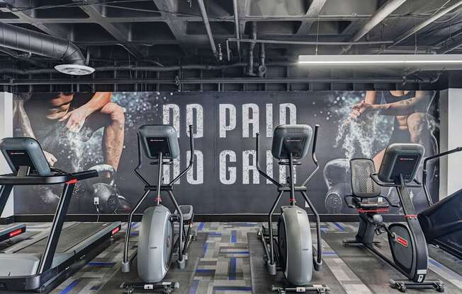 A gym with a sign that says "No Paid Gym" and exercise equipment.