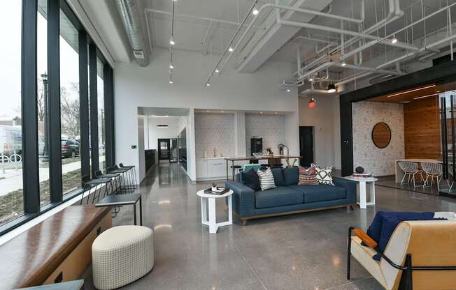 A modern living room with a blue couch and a white coffee table.