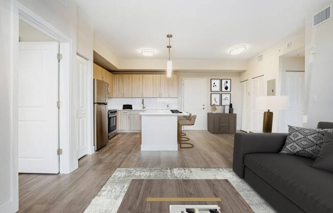 a living room and kitchen with a couch and a table