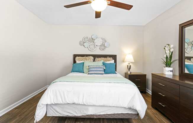 a bedroom with a bed and a ceiling fan