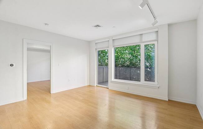 Living room with wooden floor and patio at Park77 Apartments, Massachusetts, 02138