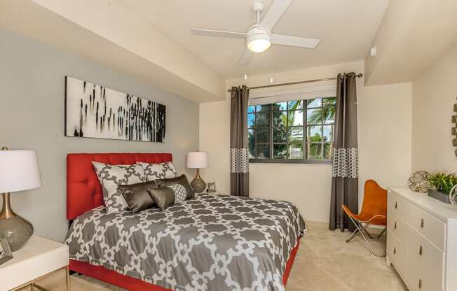 Bedroom with large window and a ceiling fan at Palm Ranch Apartments in Davie, FL