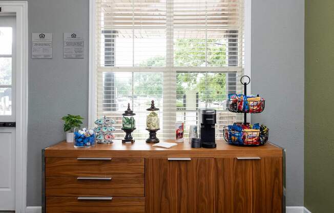 a wooden dresser in front of a window