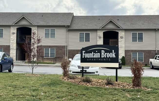 the fountain brook apartments sign in front of the building