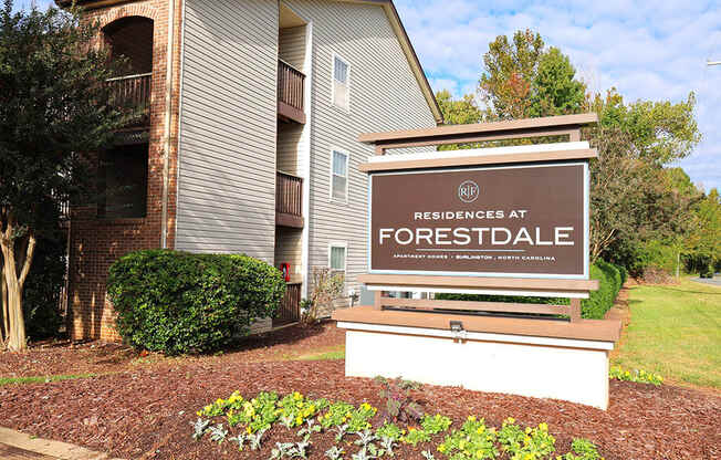 a sign for residences at forestdale apartments