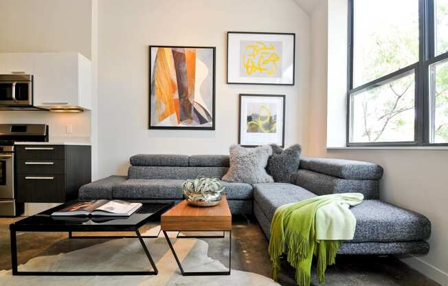 a living room with a gray couch and a coffee table