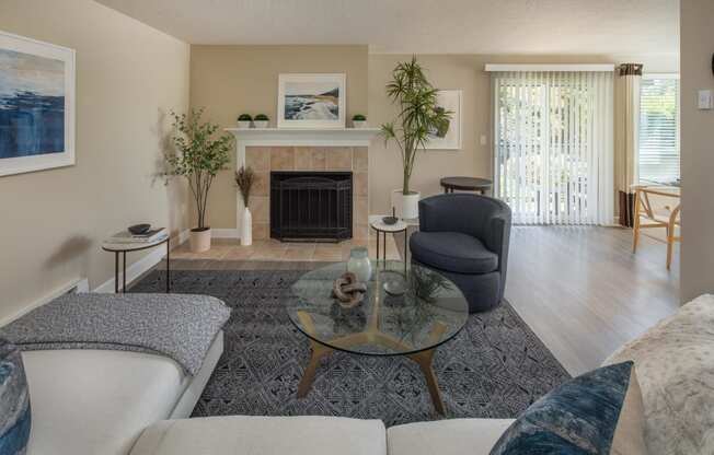 a living room with a couch and a chair and a fireplace