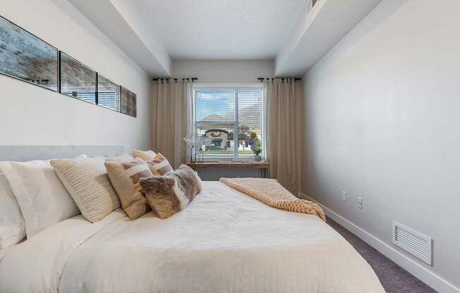 a bedroom with a large bed and a window