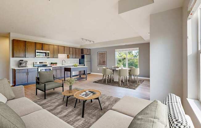 A modern living room with a kitchen in the background.