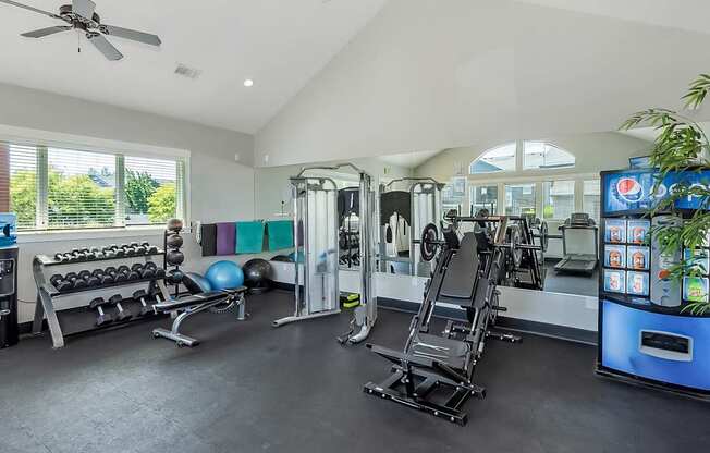 A spacious gym with a variety of equipment at The Landing Apartments and Townhomes, Oregon, 97045