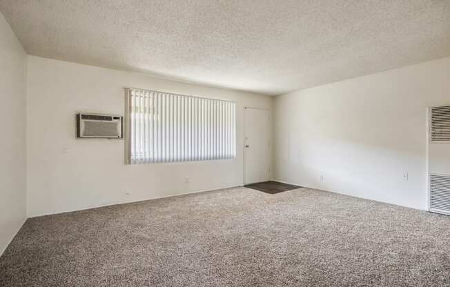 Living room with carpeted floors, air conditioning