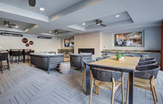 A modern dining room with a wooden table and chairs.