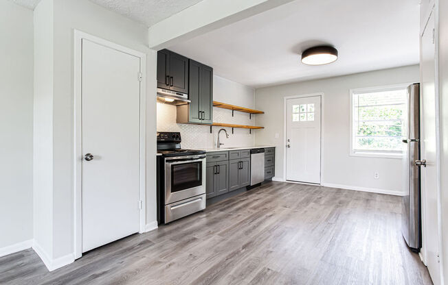 a kitchen with gray cabinets and stainless steel appliances  at The Oasis on Cascade, Atlanta, GA, 30310