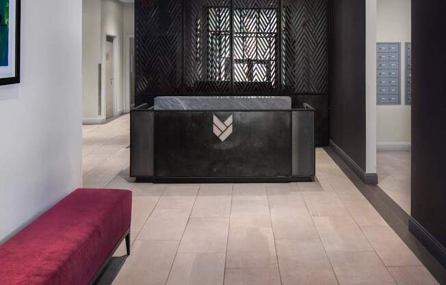 A black reception desk with a logo on it.