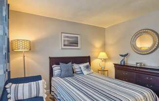 a bedroom with a bed and a chair