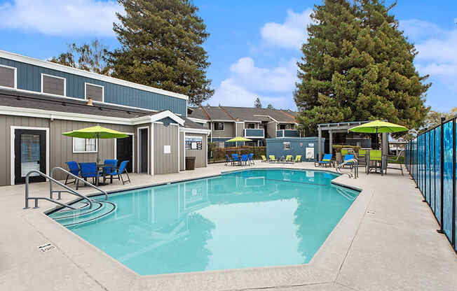 Community Swimming Pool with Pool Furniture at Meritage Apartments in Vallejo, CA.