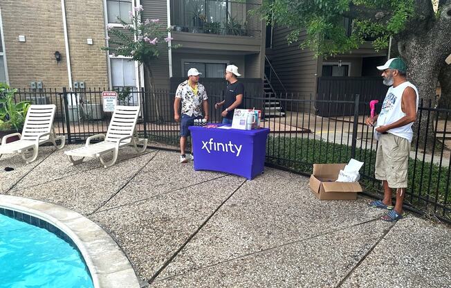 Three men are standing around a purple box labeled