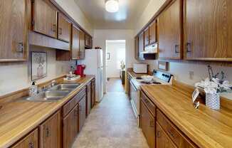 a galley style kitchen with a refrigerator and stove